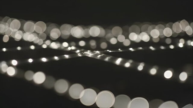 Blurry white lights on black background.