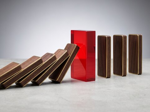 domino effect stopping at a bright red obstacle conceptualizing resilience and change resistance