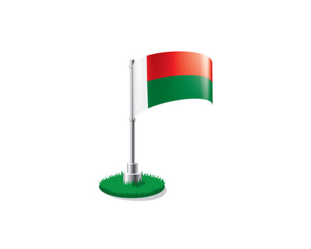 Madagascar flag on a flagpole mounted on the grass