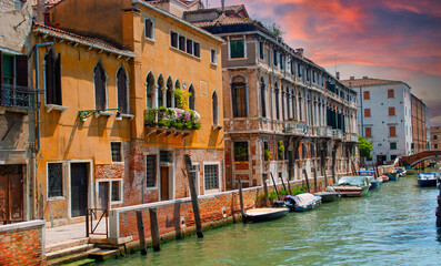 Obraz premium historic buildings with decorated balconies and Venetian Gothic-style windows, which overlook the water of the Grand Canal directly
