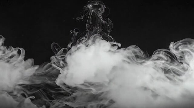 Dense white smoke billows across a solid black background in a studio setting