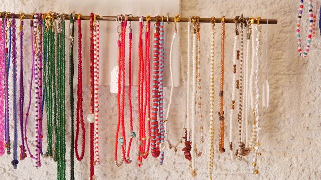 Colorful necklaces hanging for sale at a market