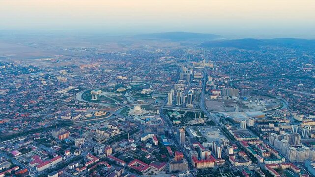 Grozny, Russia. City center panorama at twilight, Drone footage over the Grozny-City Towers and the Heart of Chechnya Mosque with soft post-sunset light across the skyline. Drone footage