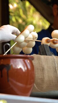 Traditional Japanese Dango Skewers Grilling Over Charcoal in Tokyo