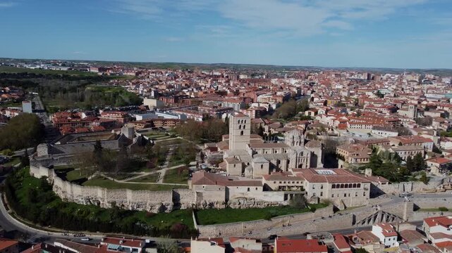 4K aerial drone view of the historic city of Zamora, Spain. Panoramic shot featuring the Romanesque Cathedral, ancient castle ruins, and medieval walls, bridging the old town with the modern city
