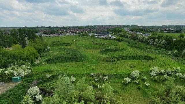 Drone parallax rising aerial shot over M1 Junction 39 landscape in Wakefield