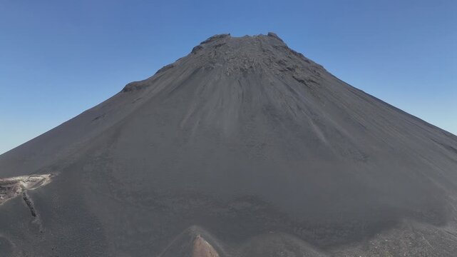 Aerial close-up of the sharp, rugged crater rim and jagged rocky peaks of Pico do Fogo, showcasing the desolate volcanic terrain and steep ridges in Cabo Verde