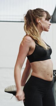 Woman, earphones and stretching with legs in city for wellness, muscle and streaming in morning. Girl, warm up and listen to music with fitness with audio, subscription and sound in urban town