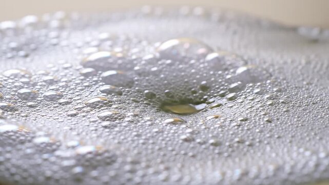 Water droplets on reflective surface highlighting geometric patterns and contemporary art