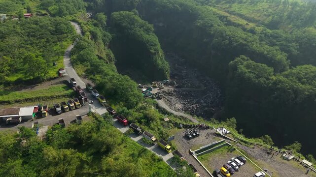 Aerial view of Tambang Pasir Merapi Kali Gendol Sand Mine with deep canyons and lush green slopes in Kecamatan Cangkringan, Daerah Istimewa Yogya, Indonesia.