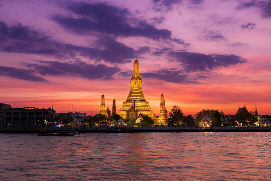Wat Arun the Bangkok Thailand heritage famous temple landmark in the riverside at the sunset with twilight sky landscape
