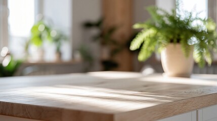 Fototapeta premium Bright, Sunlit Wooden Tabletop with Potted Green Plant in Soft Focus Home Interior