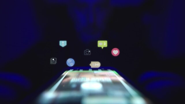 Smartphone automatically scrolling through a social media feed with vibrant like and heart reactions floating upwards.