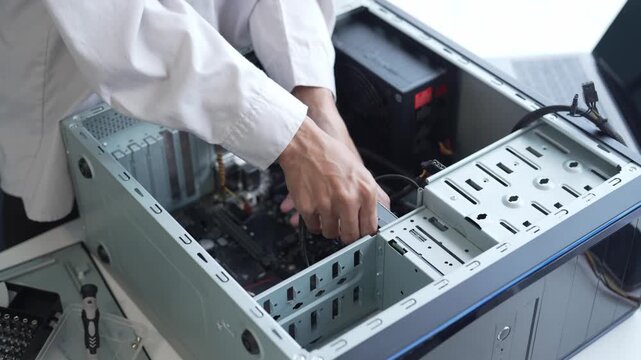 Asian man using screwdriver maintenance computer