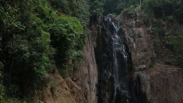 Low flow volume from the Haew Narok waterfall in the dry season. Rain forest at Khao Yai National Park in Thailand.