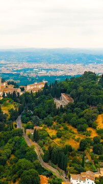 Vertical video. Florence, Italy. Fiesole hill town and ancient Roman theatre, aerial panoramic view over the Tuscan landscape with Florence sprawling in the distant valley. Drone footage. Rich colors