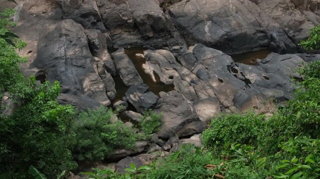 Low flow volume from the Haew Narok waterfall in the dry season. Rain forest at Khao Yai National Park in Thailand.