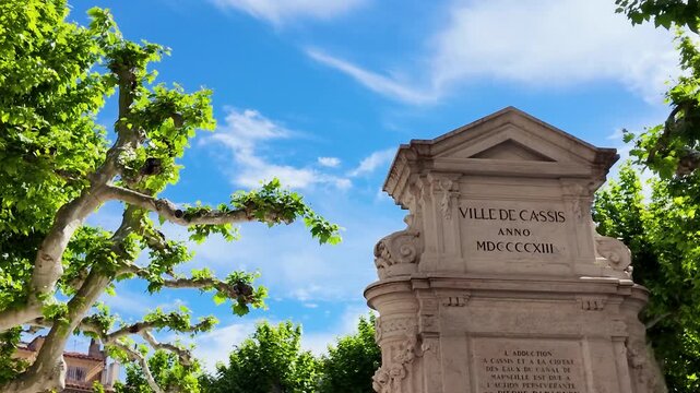 Historic Stone Fountain Monument in Cassis France Under Blue Summer Sky