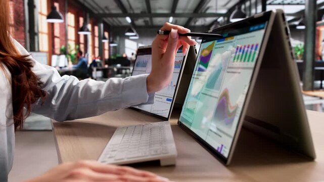 Person Uses Laptop To Review Financial Data