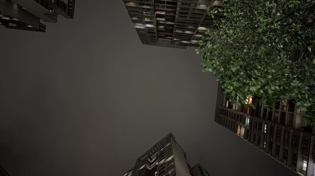 Dramatic timelapse of fast-moving storm clouds and sudden lightning strike over city buildings.