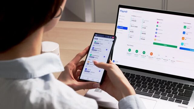 Human Resource Manager Reviewing Employee Data On Smartphone