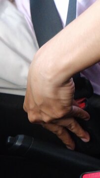 The process of clipping the seat belt in the car close up