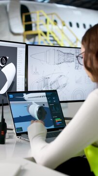 Engineer Carefully Checks Aerospace Parts On Laptop