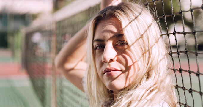 Serious, relax and portrait of woman outdoor on spring break with confidence by fence in morning. Scholarship, gen z and female student by tennis net on weekend with calm attitude and pride.