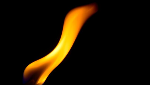 A solitary flame burning brightly against a dark, undefined background.
