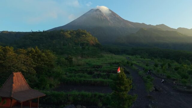 Aerial view of Bunker Kaliadem Merapi with a traditional joglo house surrounded by lush green hills and volcanic terrain Kecamatan Pakem, Daerah Istimewa Yogya, Indonesia.
