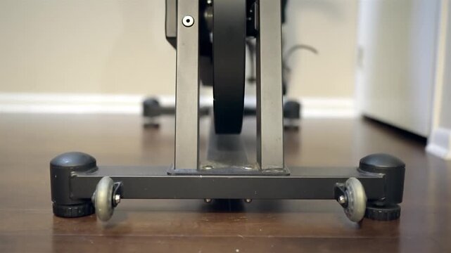 Person cycling stationary exercise bike at home for daily fitness