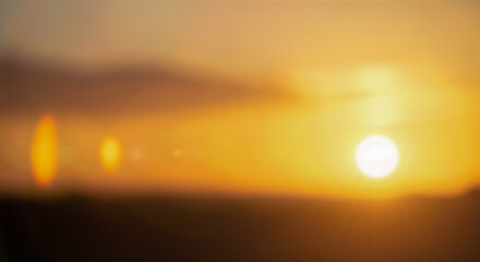 Abstract blurry sunset sky background with bright sun lens flare glowing orange yellow light soft natural bokeh effect for summer evening nature landscape design © Celt Studio