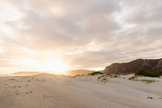 muted sunset light over Grotto lagoon and sand dunes, Hermanus, South Africa