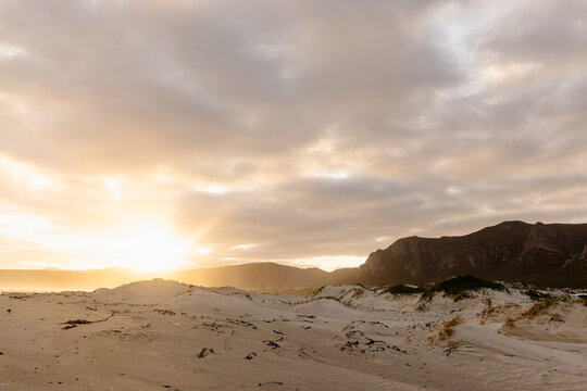 muted sunset light over Grotto lagoon and sand dunes, Hermanus, South Africa
