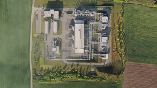 Aerial view of the UGS Damborice gas storage facility with industrial pipes and buildings surrounded by green fields Damborice, South Moravian Region, Czechia.