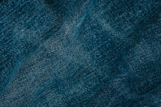 Denim fabric texture with folds and wrinkles