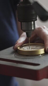 Artisan using drill press machine for crafting