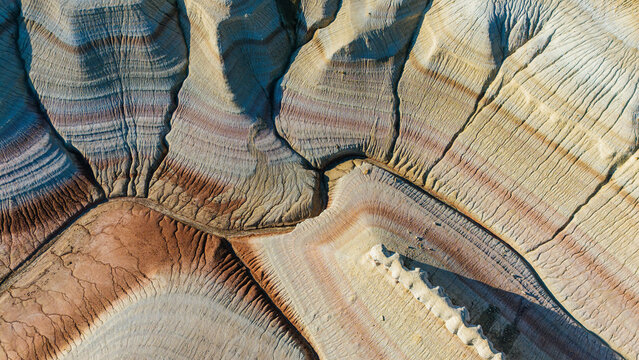 multicolored canyon at sunset Kyzylkup is a natural landmark in the Mangystau region of Kazakhstan. It is a group of colorful hills with multicolored layered slopes that resemble the Italian dessert t