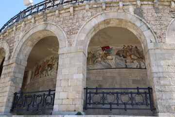 Arcade with a mural on the wall of the Skanderbeg Museum in the city of Kruja, Albania © bummi100
