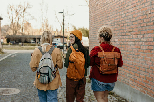 Female students walking together on a college campus street