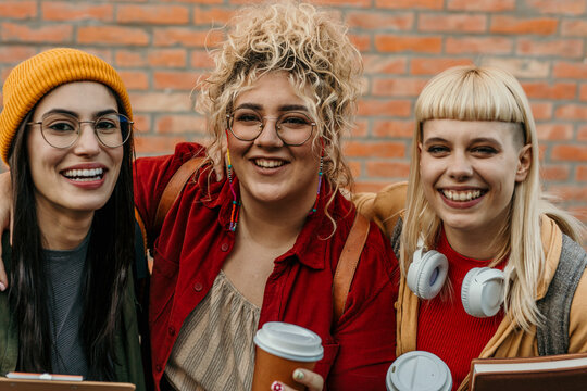 Diverse students smiling together enjoying urban friendship