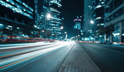 Fototapeta premium Urban Night Cityscape with Blurry Light Trails from Moving Cars on a Busy Roadway