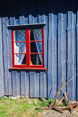 Red window on an old wooden cottage © Lars Johansson