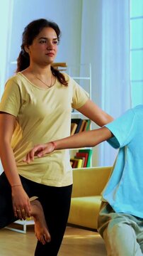 Indian family doing parvatasana yoga at home practicing mountain pose together indoors for healthy body and calm mind during morning routine inside a modern lavish living space