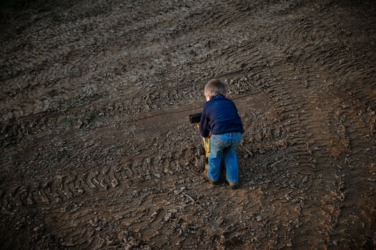 Toddler Playing On Muddy Construction Ground