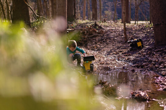 Child Playing With Toy Truck Creekside