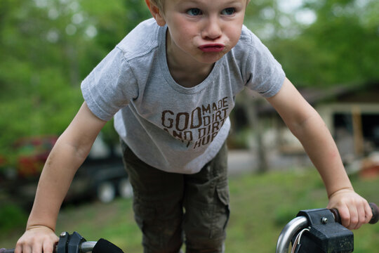 Playful Young Boy On Bicycle
