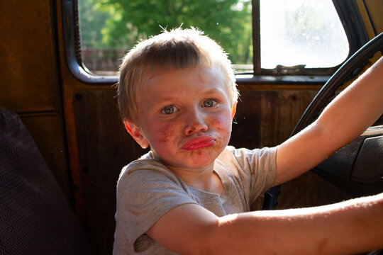 Close Up Of Dirty Child Playing In Old Truck