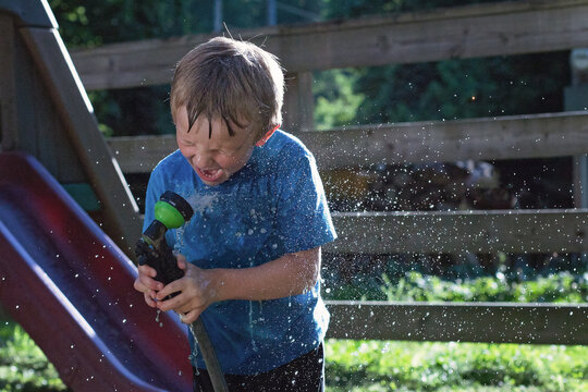 Child Drinking From Water Hose