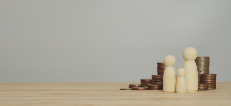 Family protection concept using wooden figurines and security shield representing life insurance, financial safety and long term savings planning for household stability.